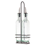 Two clear green tint glass bottles with stainless steel pourers sit side by side in a chrome plated rack with a handle. The rectangular bottles have rounded edges, and the holder features horizontal bars to keep them secure.