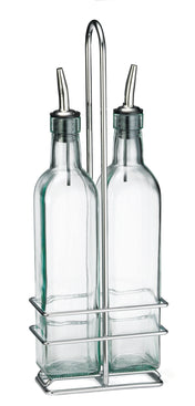 Two clear glass bottles with stainless steel pourers sit side by side in a chrome plated rack with a tall handle, against a white background. The rectangular bottles have rounded shoulders and long necks, making an elegant glass bottle set for your table.