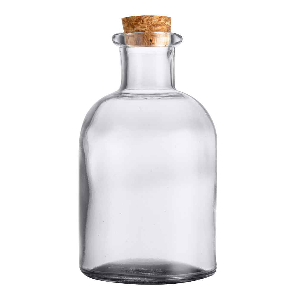 A TableCraft clear glass bottle with a wide neck and rounded shoulders, sealed with a natural cork stopper. Perfect as an olive oil bottle, it sits empty against a plain white background.