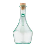 Clear olive oil bottle with a wide base, narrow neck, and wooden cork stopper. An inner glass tube is fused inside, extending from the neck. Made from green tint glass by TableCraft, the empty bottle is set against a white background.