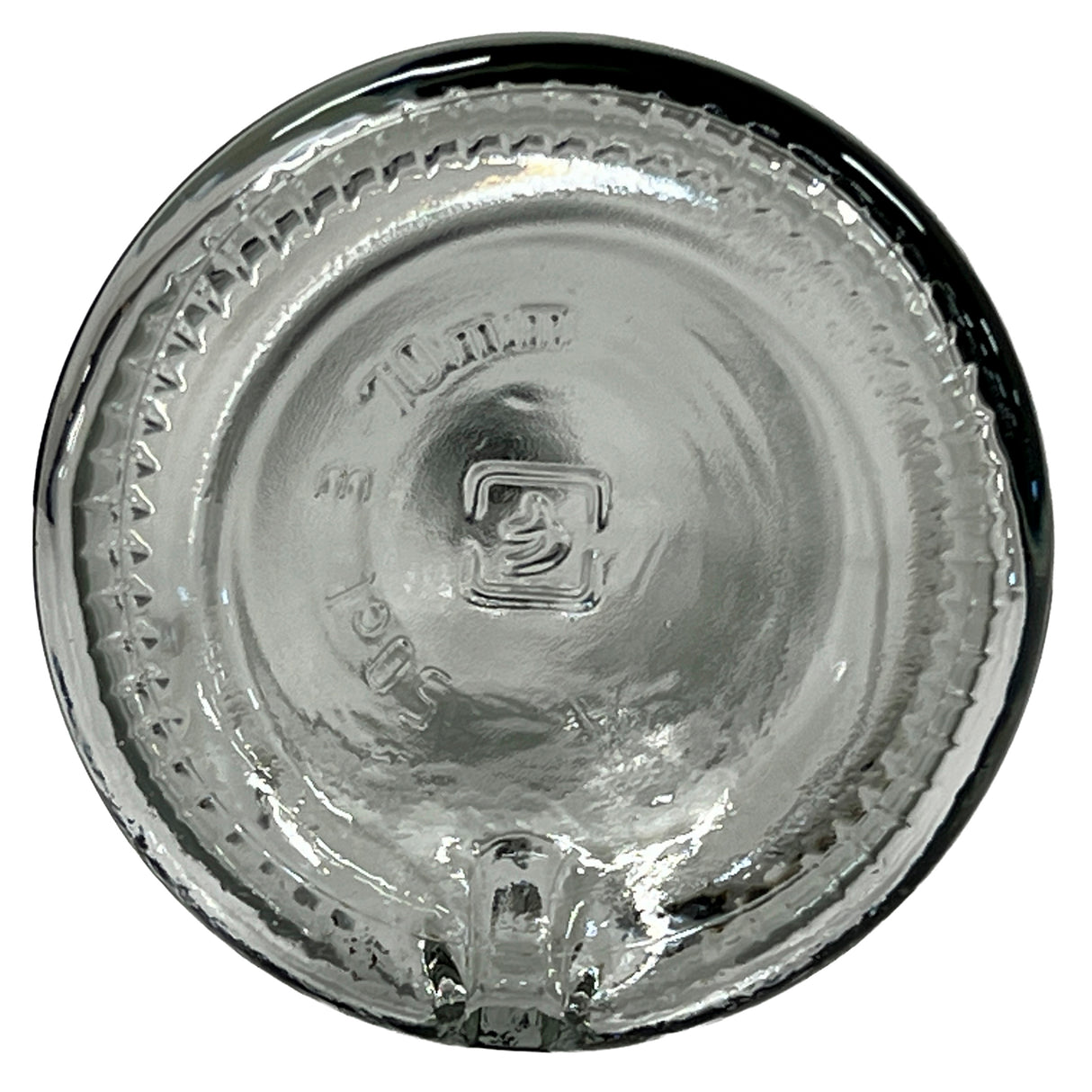 Clear Sottile Glass Bottle bottom viewed from above, showing raised markings including TURKEY, a square logo with the number 2, and “3061.” Textured ridges line the edge; a small indentation appears near the rim. Capacity: 17 oz.