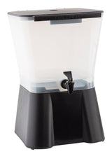 A large, clear 3 gallon beverage dispenser with a black base and spigot. The rectangular container, labeled TABLECRAFT on top, is partially filled with liquid and sits on a sturdy, elevated stand. Dishwasher safe for easy cleaning.