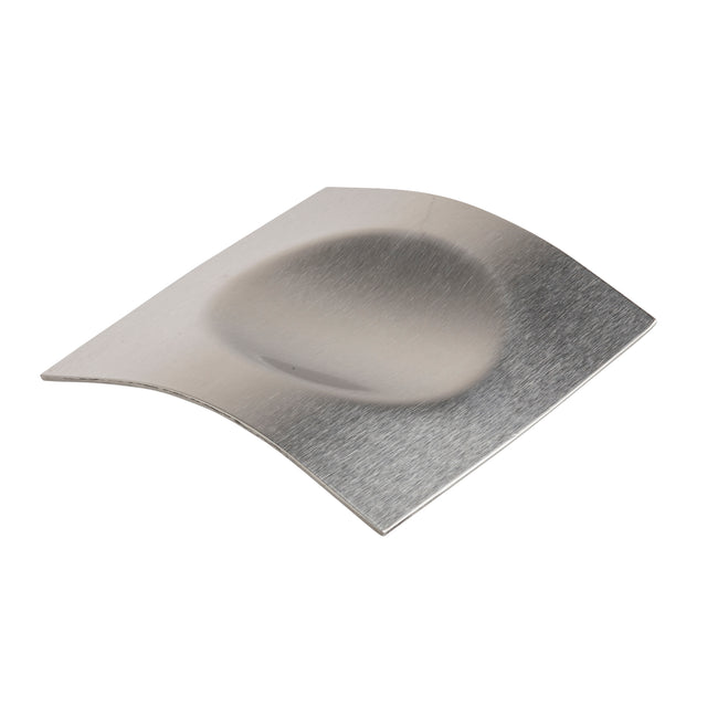 A flat, rectangular, metallic stainless steel spoon rest with a brushed finish, featuring a large, shallow oval depression in the center and subtly curved edges, photographed against a white background. Dishwasher safe for easy cleanup.