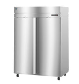 A large, commercial stainless steel refrigerator with two vertical stainless steel doors, mounted on black wheels. The shiny surface features a small electronic display and brand logo on the upper right section of the front panel.