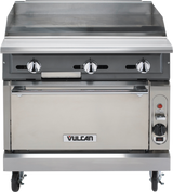 A commercial stainless steel Vulcan heavy duty range featuring a flat gas griddle, three control knobs, an oven door below with the Vulcan logo, casters for mobility, plus a red ignition button and temperature dial on the lower right.