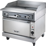 A commercial-grade heavy duty range with a flat gas griddle top, standard oven below, three control knobs, and casters for mobility. The Vulcan brand is visible on the sleek, utilitarian stainless steel design.