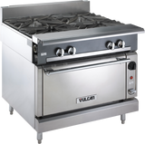 A stainless steel Heavy Duty Range with four large gas burners on top, control knobs on the front panel, a standard oven below with handle, and “Vulcan” branding on the oven door. The appliance stands sturdily on four metal legs.