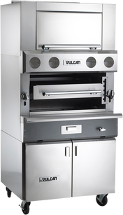 A large, heavy duty broiler with the Vulcan logo, this stainless steel commercial unit features ceramic radiant burners, a top broiling chamber with drop-down door, control knobs, middle grilling section, and a lower cabinet on caster wheels.