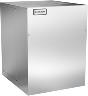 A stainless steel Ice-O-Matic Quartz Ice® Maker with an air-cooled condenser, featuring a rectangular, boxy shape and smooth metallic finish. The machine has a logo on the upper front panel and visible seams along the edges.