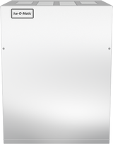 A silver, box-shaped commercial ice machine with a smooth front panel and an air-cooled condenser. The top left corner displays a label reading Ice-O-Matic. Its metallic surface is minimalistic, with visible screws near the edges.
