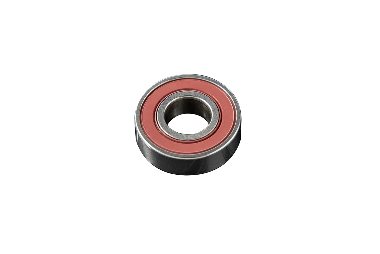A close-up of a single metal ball bearing with a reddish rubber seal around its inner ring, shown on a white background—its circular shape and smooth edges resemble precision parts found in compact ice and water dispensers.
