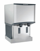 A commercial Scotsman ice and water dispenser machine with a stainless steel exterior, push-button controls, dual dispensing spouts, and a vented side panel. This countertop nugget ice machine combines style and functionality for any setting.