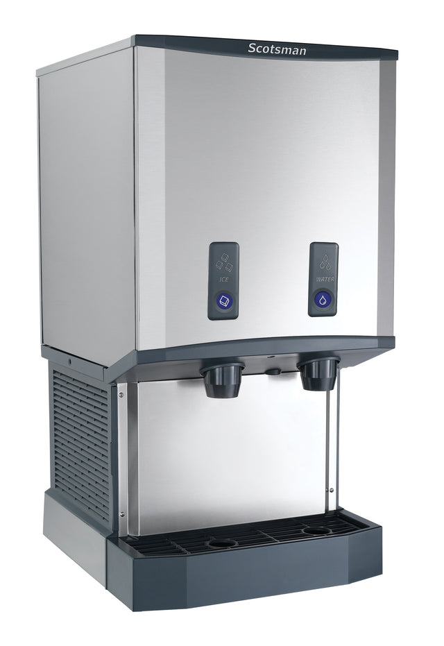 A stainless steel Meridian ice and water dispenser with two black dispensing nozzles, labeled buttons for ice and water, a drip tray below, and a modern, boxy design suitable for commercial or office use.