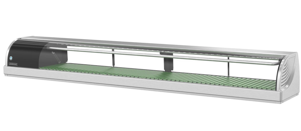 A sleek Hoshizaki refrigerated sushi case, this countertop display case features stainless steel and glass construction, a green textured base for showcasing sushi, clear glass front, and a black-panel end with a circular logo. The unit is empty and well-lit.