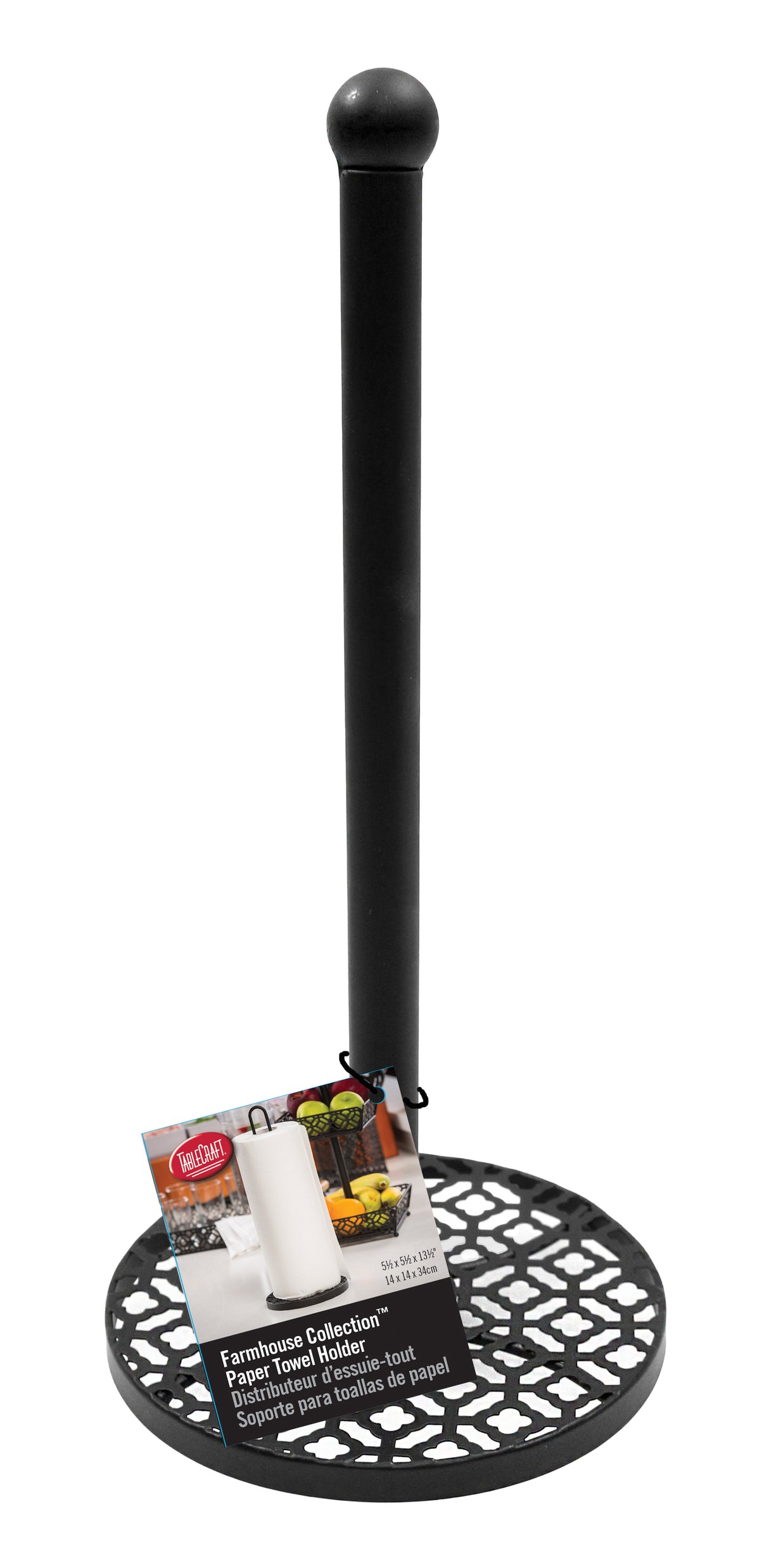 A black metal farmhouse paper towel holder with a decorative, open lattice base and smooth vertical rod topped with a rounded end. An attached product card shows the tabletop paper towel holder in use, with details in English and French.