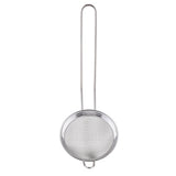 A stainless steel cocktail strainer with a fine mesh, featuring a round sieve and a long, thin handle. The strainer stands upright against a white background, its handle extending vertically above the circular mesh.