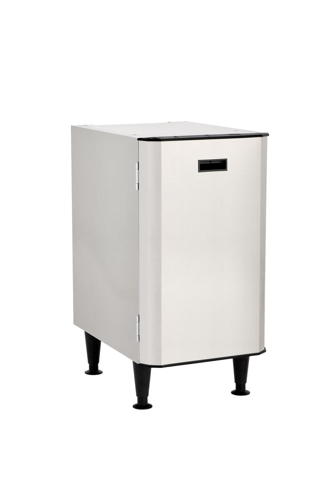 A stainless steel, rectangular, freestanding appliance with a front-facing door, black base, and four black adjustable legs. The minimal, industrial design includes an interior storage shelf and is photographed against a white background.
