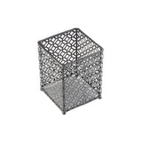 A black powder coated, square metal pen holder with an intricate geometric cutout pattern on all sides. It stands on four small round feet and has an open top, perfect for organizing pens or as a cutlery holder from the farmhouse collection. Background is plain white.