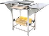 The Hobart Hand Wrap Station features a stainless steel flat workspace, center heat plate, and front cutting blade. Designed for commercial food packaging, it accommodates 20 film capacity rolls mounted below and stands sturdily on four legs.