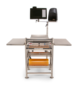 A stainless steel Energy Smart Hand Wrap Station features a roller conveyor, two side tables, a mounted monitor, label printer, roll film capacity underneath, and a clean design—ideal for efficient packaging or sorting tasks.