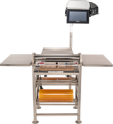 An Energy Smart Hand Wrap Station with roll film capacity features two side trays, a heated seal plate, an orange film roll on a lower rack, a flat working surface, and a touchscreen display mounted above. The background is plain white.