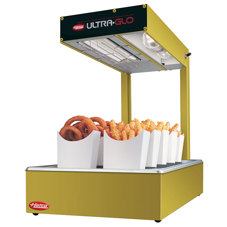 A yellow Hatco Ultra-Glo countertop warmer displays trays of fried foods, including onion rings and crinkle-cut fries, under a heating lamp. The rectangular top is labeled “Ultra-Glo” and holds food in upright white paper cartons.