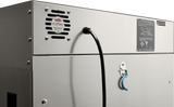Close-up of the back of a Vulcan VBP13ES mobile food warmer showing a black power cord plugged in, ventilation grill, metal information plate with text, and a blue latch handle. The clean stainless steel surface reflects light for an industrial look.
