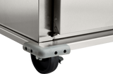 Close-up view of the bottom corner of a stainless steel institutional cabinet, showing a black caster wheel, protective gray corner bumper with black dots, and part of the metal frame with screws and joint details. The background is plain white.