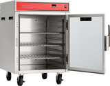 A mobile stainless steel Holding/Transport Cabinet stands on four wheels, its glass door open to reveal three wire shelves inside. The cabinet features a red control panel on top displaying temperature and buttons, and the interior is empty.