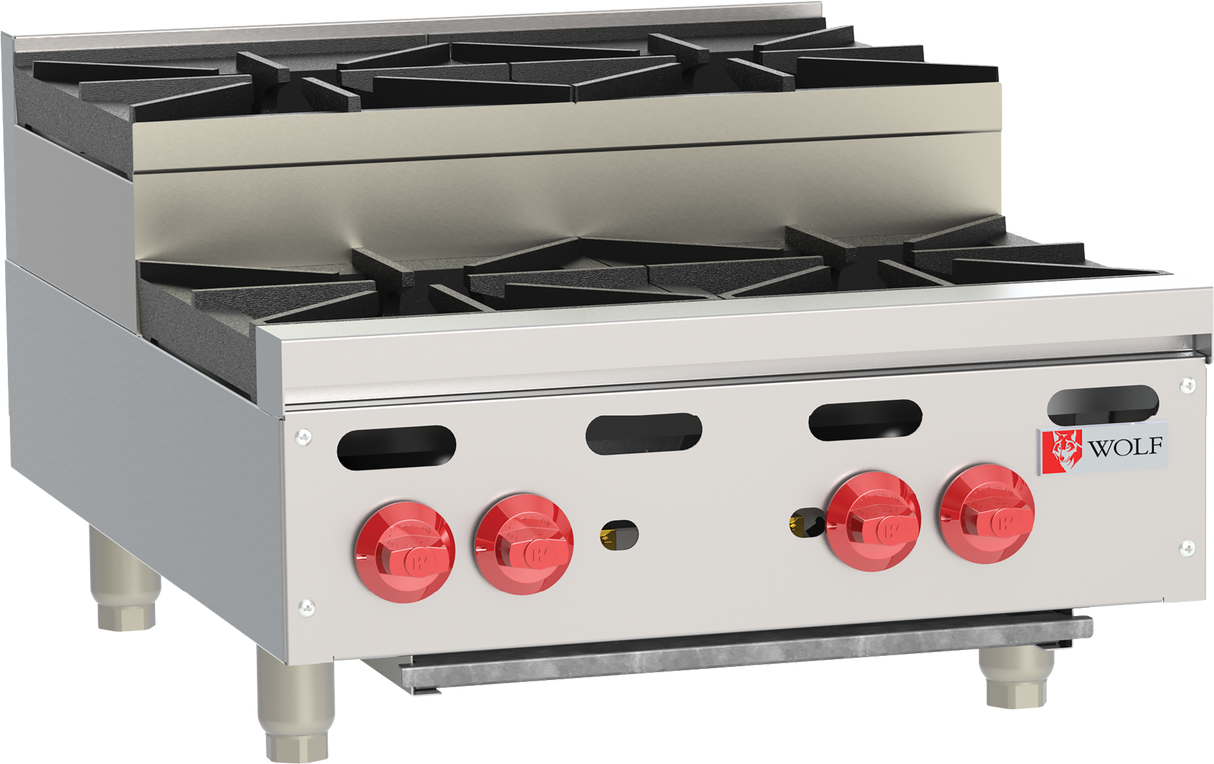 A commercial stainless steel gas range, the Wolf Achiever Hotplate features four black cast-iron burners, four red control knobs, and the Wolf logo on the front right panel. This heavy-duty gas countertop cooking appliance is elevated on short legs for durability.