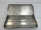A rectangular metal sheet with three angled bends forms a stepped surface, resembling a bin deflector used in Icetro America upright bins. Two vertical side flanges show visible spot welds. The brushed, slightly reflective finish displays surface marks and circular patterns.
