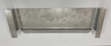 A rectangular, metallic wall-mounted shelf with raised sides and a small horizontal ledge at the bottom, this simple utilitarian piece could serve as a beverage dispenser deflector for Icetro America models. The brushed metal finish adds an industrial touch.