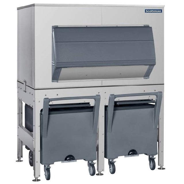 A large commercial top-mounted ice maker with a stainless steel exterior, gray front door, and two gray rolling ice storage bins beneath it. The unit features the Ice Express Transport System and Scotsman branding in the top right corner.