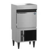A Hoshizaki commercial stainless steel Specialty Cube-Style Ice Maker with a top ice bin, drop-down front door, lower ventilation panel with power switch, four black legs, and a blue and white circular badge on the upper right door.