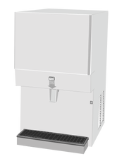 A white, box-shaped Ice Maker Dispenser with a wide chute for nugget-style ice, a black drip tray at the bottom, and vent grilles on the side. The front displays a small sign labeled “ICE.” The machine stands alone against a plain background.