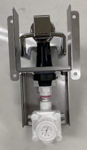 A metal wall-mounted bracket holds an Icetro America chrome and black dispenser above a white plastic valve assembly with a pink ring, set against a plain surface. The components are aligned vertically and securely attached to the bracket.