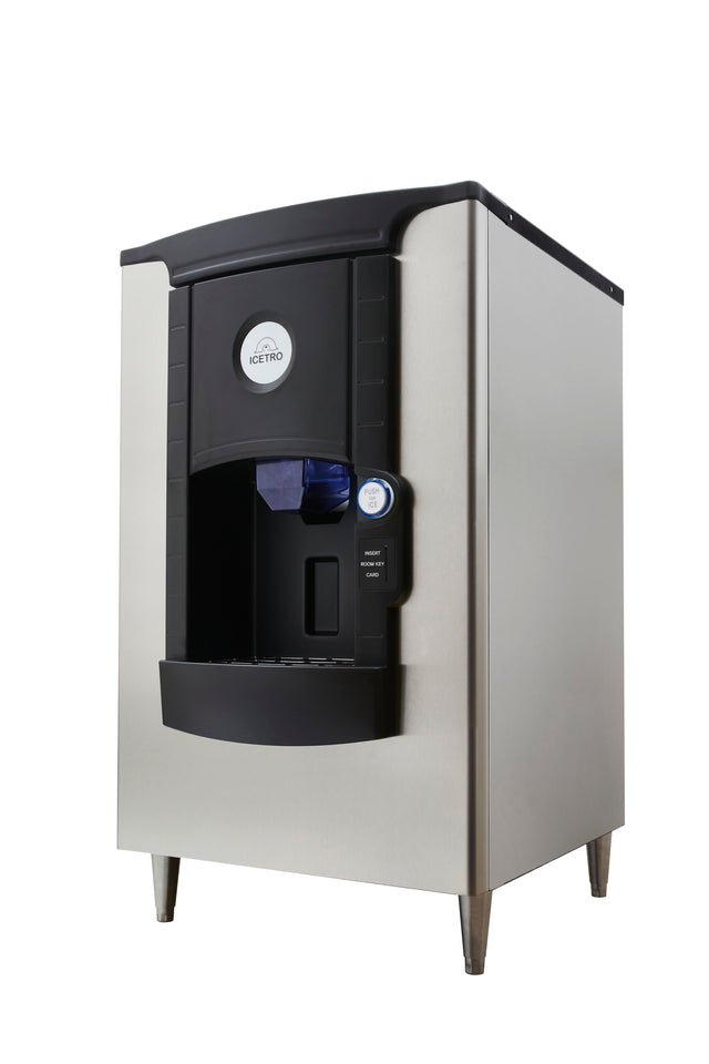 A stainless steel Icetro America ice dispenser stands on four legs. The machine has a curved black front panel with a round ICETRO logo, a large dispensing area, and a blue push-button for ice release on the right side—perfect for hotel use.