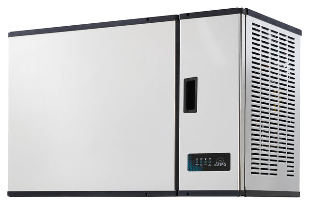 A large, rectangular high capacity ice maker with a vented panel, digital display, and handle on the front. The unit is wall-mounted, featuring a modern, industrial look with clean lines and a white front panel.