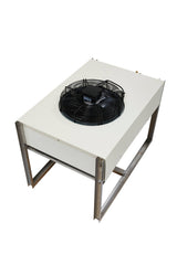 A rectangular industrial cooling unit from Icetro America with a white metal body stands on metal legs. This pre-charged remote condenser features a large black fan with a protective grille on top and brass fittings at the back, all set against a plain white background.