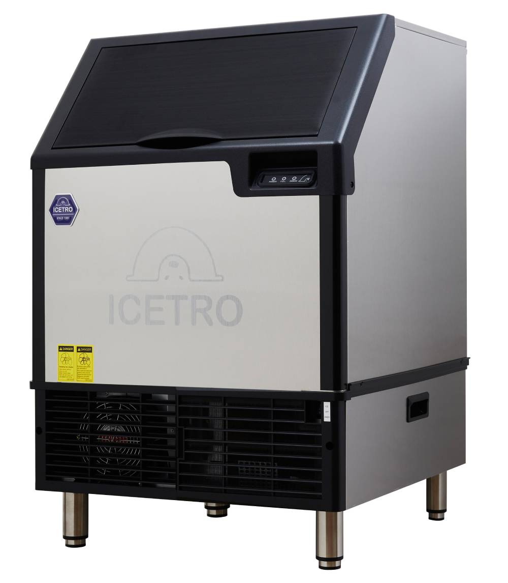 A stainless steel exterior ICETRO cube-style ice maker with a black top lid, control buttons on the front right, side vents, and sturdy legs. The ICETRO logo and a small blue sticker are visible on the front panel.
