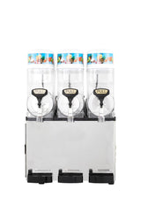 A commercial Icetro America frozen beverage dispenser with three clear, vertical tanks labeled “PULL.” The tanks, topped with vibrant fruit graphics, rest on a silver base with drip trays. The slush machine stands out against a white background.