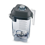 A transparent Vitamix blender container with clear measurement markings and a large Advance blade assembly inside. The 32 oz Tritan container features a black plastic lid with removable center cap, side handle, and a square base with curved edges.