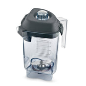 A transparent Vitamix blender container with clear measurement markings and a large Advance blade assembly inside. The 32 oz Tritan container features a black plastic lid with removable center cap, side handle, and a square base with curved edges.