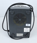 Bottom view of a black Robot Coupe R301U.D commercial food processor with four rubber feet, a circular vent with metal mesh, a coiled power cord, and several white labels, including a warning and number 22. The background is plain and light gray—ideal for efficient vegetable prep in any professional kitchen.