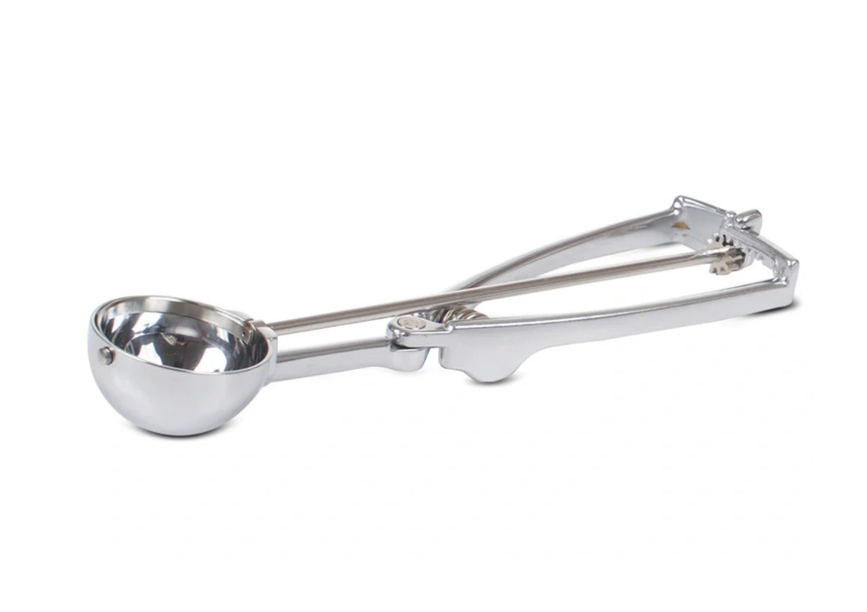 A shiny stainless steel Stockel Scoop with a round bowl and a squeeze handle mechanism featuring gears for easy release. The scoop is positioned on a white background, highlighting its reflective surface and simple design.