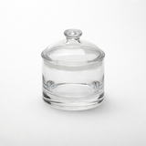 A clear jar with lid, this 35 oz jar is cylindrical with smooth, transparent glass and a matching round lid featuring a knob handle. It sits on a white background, its clarity enhanced by even lighting and free from any labels or markings.