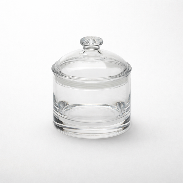 A clear jar with lid, this 35 oz jar is cylindrical with smooth, transparent glass and a matching round lid featuring a knob handle. It sits on a white background, its clarity enhanced by even lighting and free from any labels or markings.