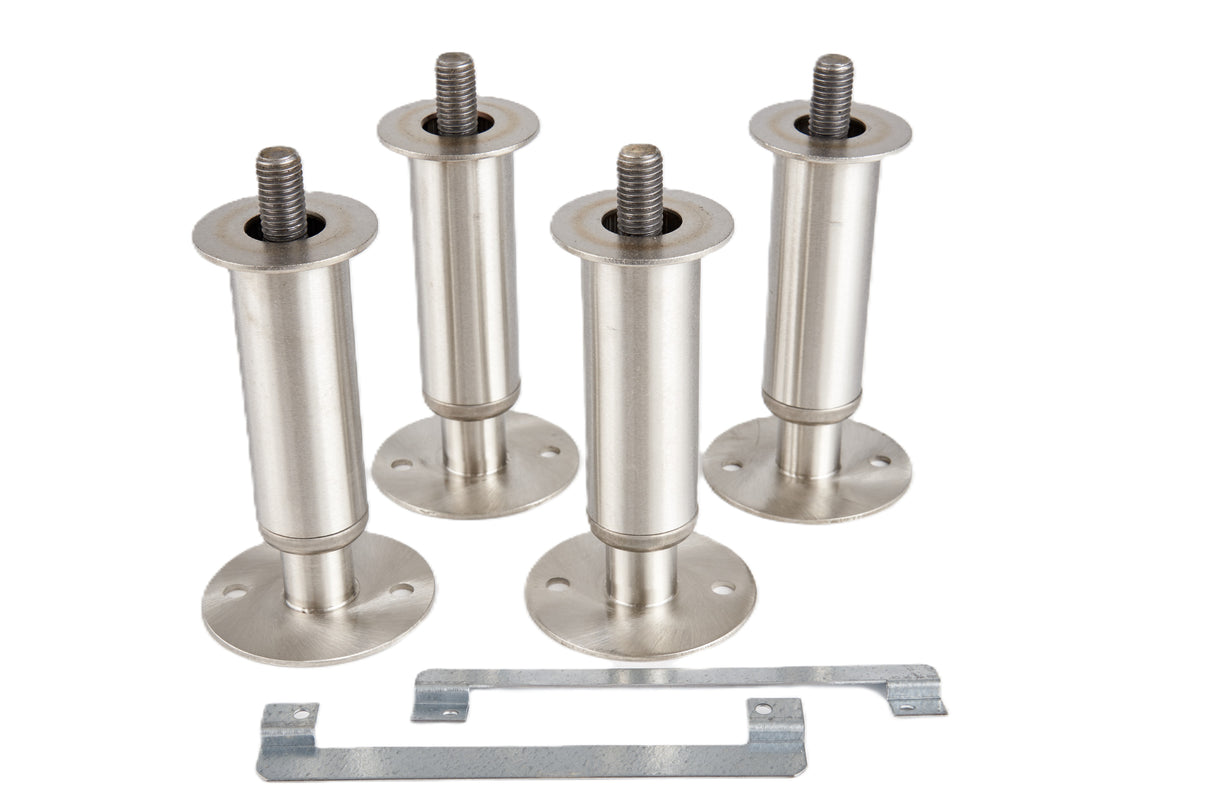 Four stainless steel cylindrical furniture legs with round mounting bases and visible screw threads are arranged in a group. In front, an adjustable flanged foot mounting bracket with angled ends and several holes is ready for secure attachment.