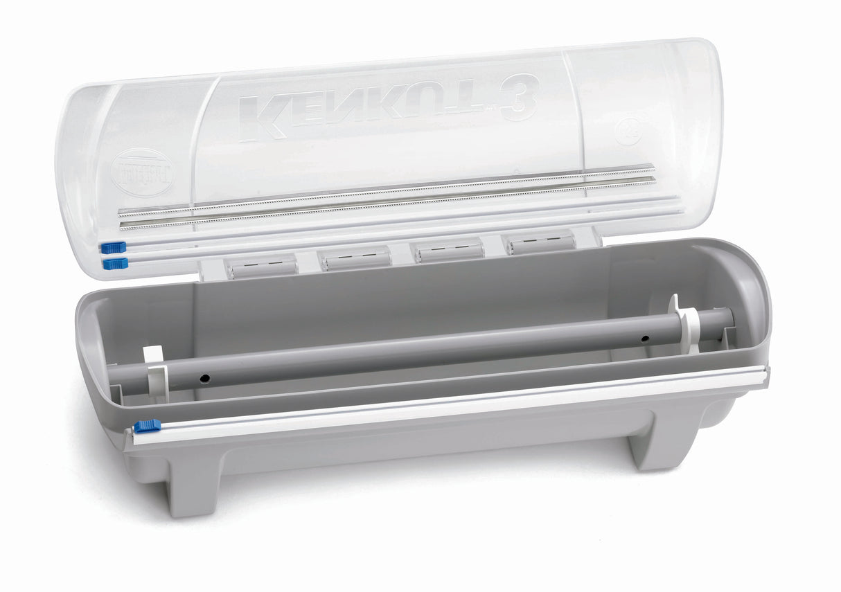A gray and transparent KenKut 3 Dispenser with an open lid reveals an empty roller mechanism inside. This plastic film dispenser features blue locking clips on each end and four small compartments under the lid.