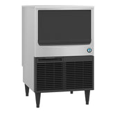 A Hoshizaki ice maker stands on four black legs. It features a large black front door above a vented lower section and a blue circular logo, stylishly designed to produce crisp crescent cube ice with modern industrial appeal.